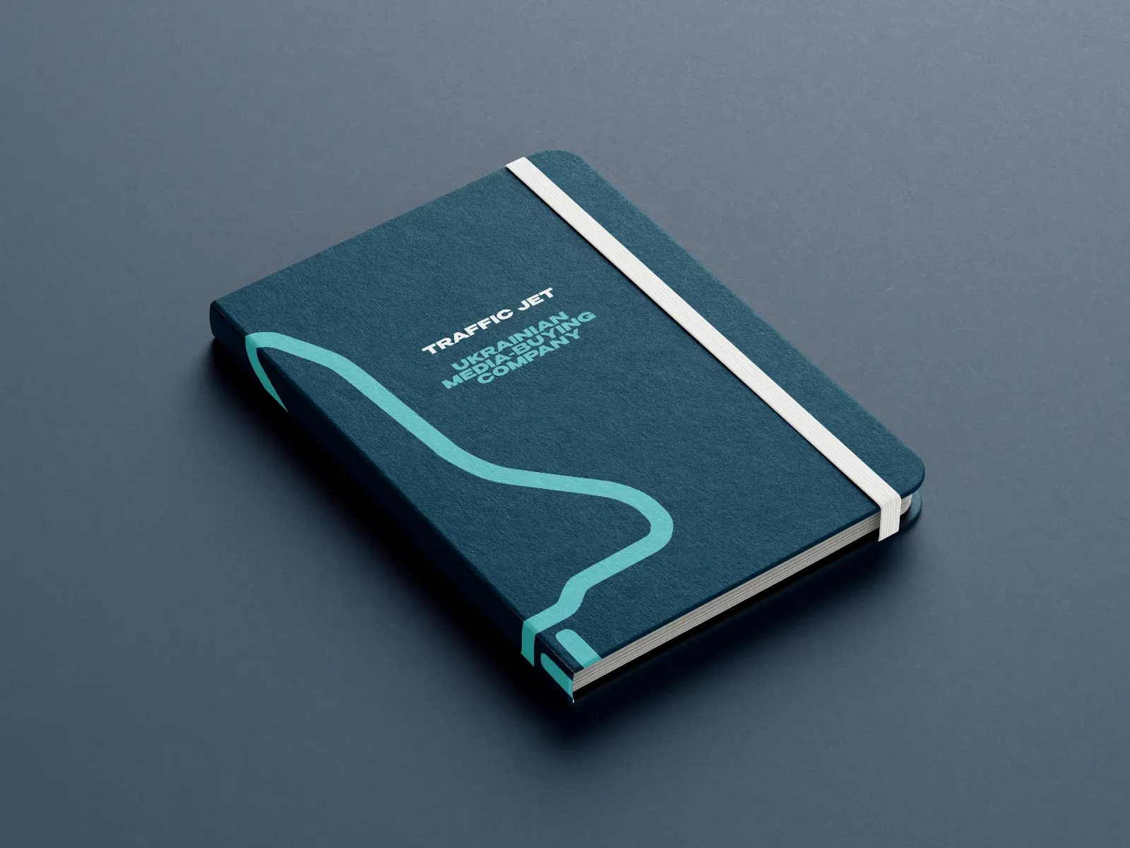 A dark teal Traffic Jet notebook with the jet trail on its cover