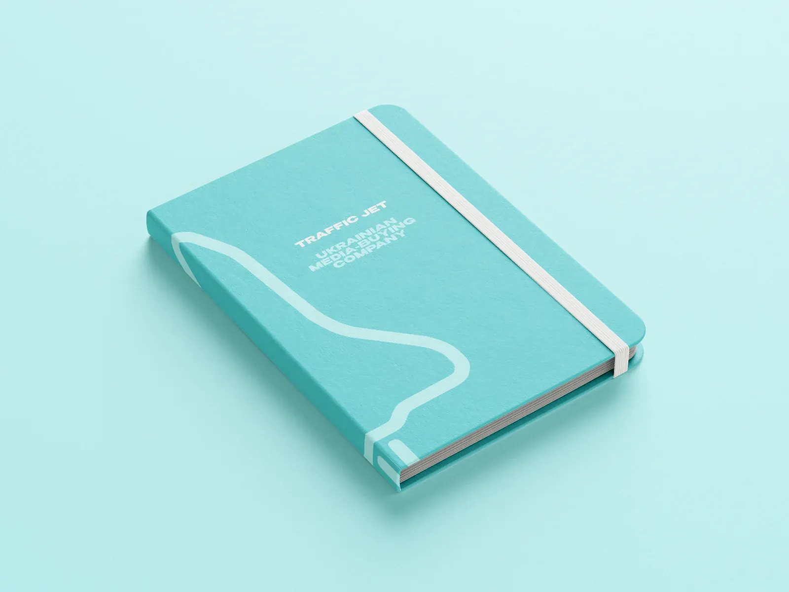 A light teal Traffic Jet notebook with the jet trail