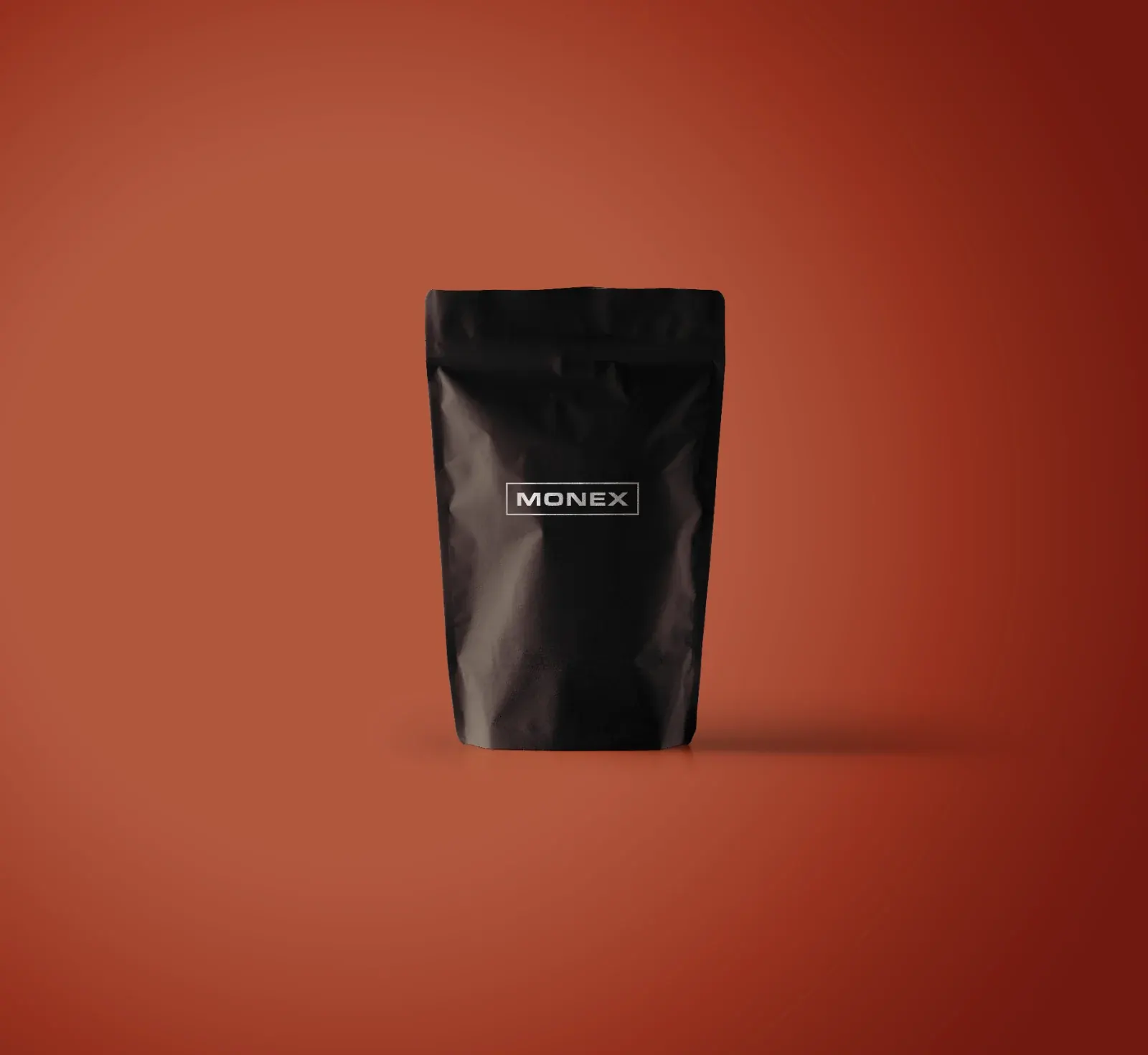 A black Monex pouch with the wordmark label on red
