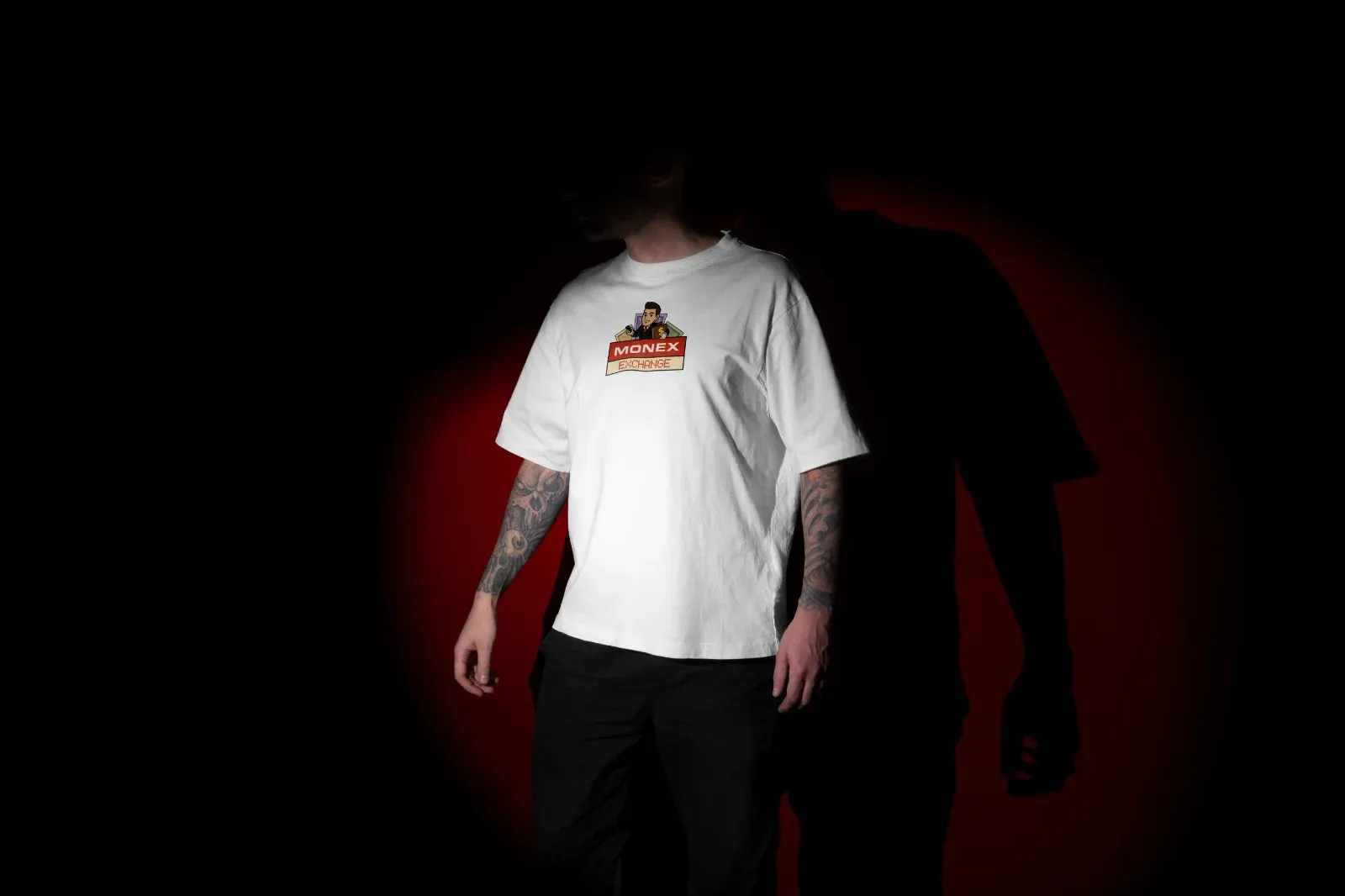 A man in a white Monex T-shirt with the mascot print